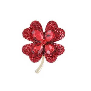 Elegant four-petal red flower brooch with sparkling rhinestones on golden base