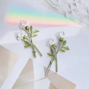 Elegant set of two white rose hair clips with green leaves in French forest style