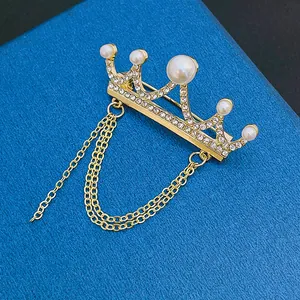 Golden crown brooch with pearls and rhinestones featuring three layers of fringe chains