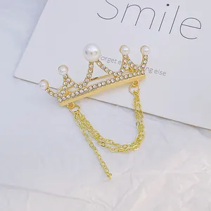 Elegant gold crown brooch with white pearls, sparkling rhinestones and double tassel chains