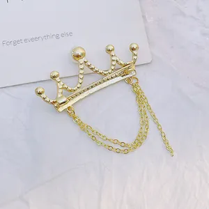 Golden crown brooch with multi-layer metal tassel chains and elegant pin closure