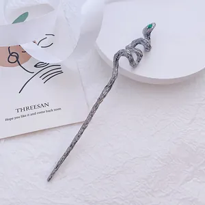 Minimalist silver snake hair pin with green gemstone accent and textured metal finish