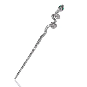 Minimalist silver snake hair pin with green gemstone eyes and detailed metal scale texture