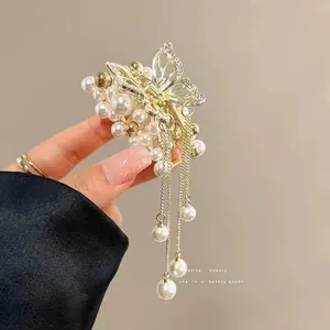 Detailed view of golden butterfly hair claw with tassels and rhinestone petals