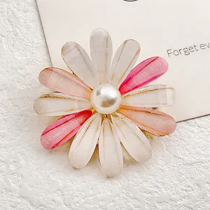 Elegant sunflower brooch with gradient pink resin petals and a white faux pearl center