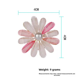 Detail view of pink and white sunflower brooch with a pearl center and 4cm size measurement