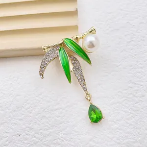 Bamboo style brooch with green enamel leaves, white pearl, and teardrop pendant