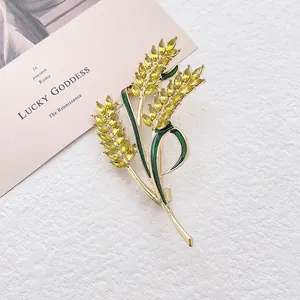 Exquisite golden wheat ear brooch with green enamel leaves and amber crystals