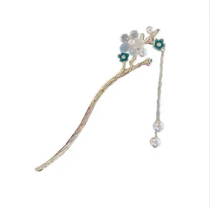 Pic à cheveux élégant muguet doré avec feuilles vertes et glands de perles