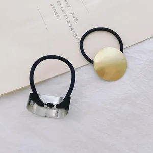 Minimalistische zwarte haarelastiekjes met vierkante accenten in goud en zilver metaal