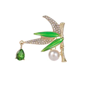 Elegant bamboo brooch with green enamel leaves, white crystals and a pear-cut drop pendant