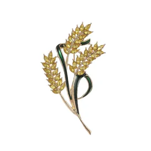 Exquisite golden wheat brooch with yellow gemstones and green enamel floral details