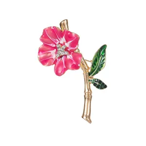 Elegant pink enamel flower brooch with rhinestones and gold-tone bamboo branch detail