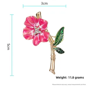 Detailed view of enamel flower brooch with rhinestones and 5cm by 3cm dimensions