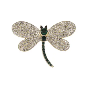 Exquise broche libellule vert émeraude avec cristaux étincelants sur base dorée