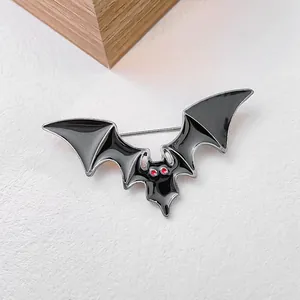 Gothic bat wing brooch with black enamel and red rhinestone eyes for Halloween suit
