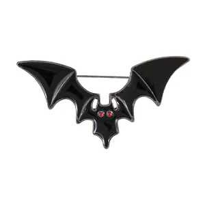 Gothic bat wing brooch with black enamel and red eyes for Halloween costume styling