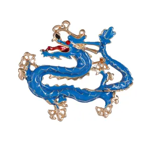 Elegant Chinese dragon brooch pin in blue enamel and gold finish with red crystal eyes