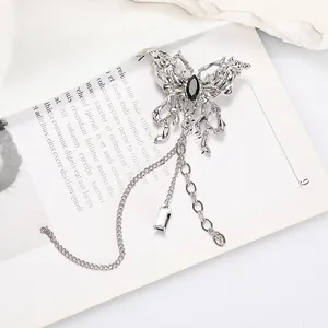 Silver liquid metal butterfly brooch with black gemstone and long tassel chain