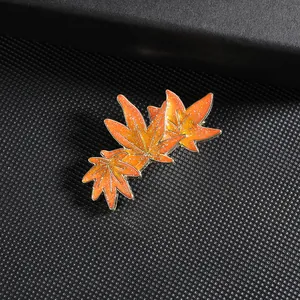 Elegant maple leaf hairpin with orange enamel finish and delicate golden outlines