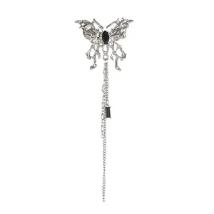 Elegant silver butterfly brooch with long tassels and black gemstones on white background