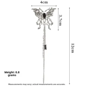 Detail view of silver butterfly brooch with black gems and long tassel measuring 12cm