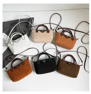 Detailed view of plush dumpling bags with leather handles and straps in six colors