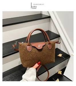 Detail of coffee brown teddy fleece shoulder bag with leather handles on a staircase