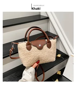 Detail of khaki faux shearling handbag with brown leather trim and metal clasp