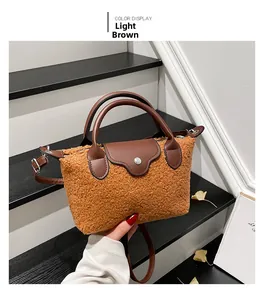 Detail of light brown fleece tote bag with dark brown leather straps on stairs