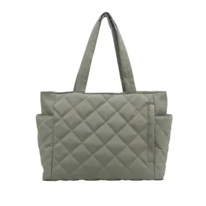 Sage green quilted tote bag with diamond stitching and multiple pockets for commuting