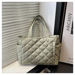 Sage green quilted tote bag with diamond pattern and side pockets for women