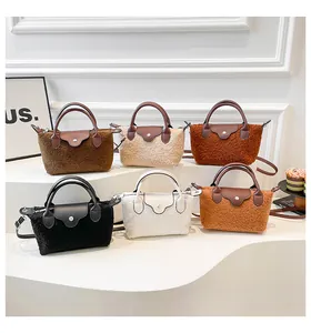 Collection of six faux shearling crossbody bags in various colors with leather flap details