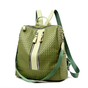 Detailed view of woven matcha green backpack with metal zippers and textured finish