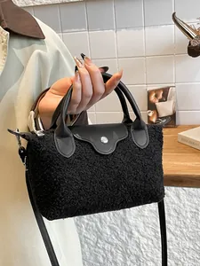Chic black plush tote bag with faux leather details and silver metal button closure