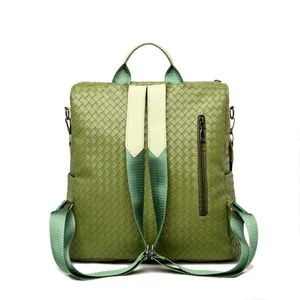 Detailed back view of green woven leather backpack featuring vertical zipper pocket