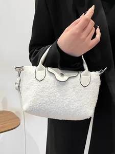 Stylish white faux fur dumpling bag with leather handle and silver buckle detail