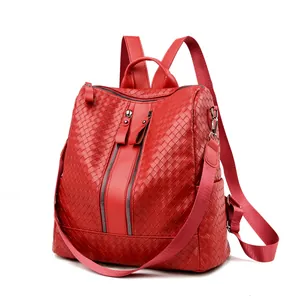 Macro shot of red woven faux leather texture and dual vertical zipper pockets
