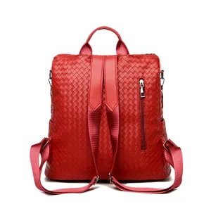 Detailed back view of red woven PU leather backpack showing adjustable straps and zipper