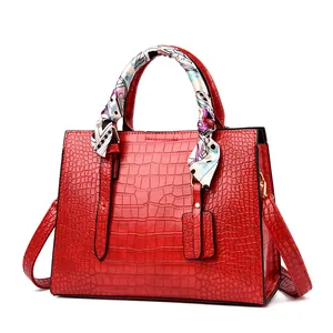 Red crocodile pattern tote bag with printed silk scarf detail and textured finish
