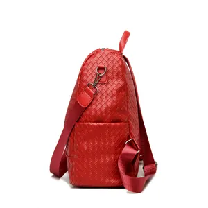 Side view of red woven PU leather backpack showing side pocket and metal buckle detail
