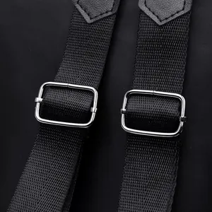 Minimalist black nylon backpack with durable strap adjustment buckle and leather detail