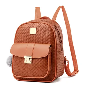 Detailed shot of brown woven PU backpack featuring a gold metal buckle and faux fur pompom