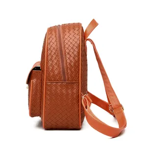 Side view of brown woven texture PU leather backpack showing zipper pocket and gold hardware