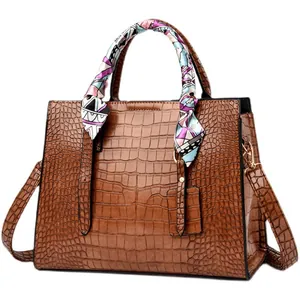 Brown crocodile pattern handbag with silk scarf handle wrap and long shoulder strap