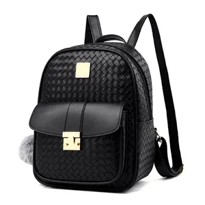 Close-up of woven texture on PU leather backpack with golden metal lock and pompom