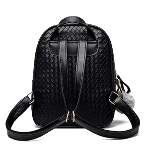 Detail view of the back of a black PU leather backpack with woven texture and gray pompom