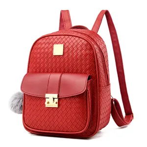 Detail of red faux leather backpack with woven texture and gold square metal buckle