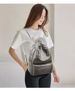 Detail of dark olive PU leather backpack with vintage texture and wide fabric straps