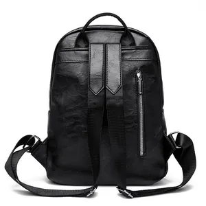 Detail view of the black PU leather backpack back with adjustable straps and zipper pocket